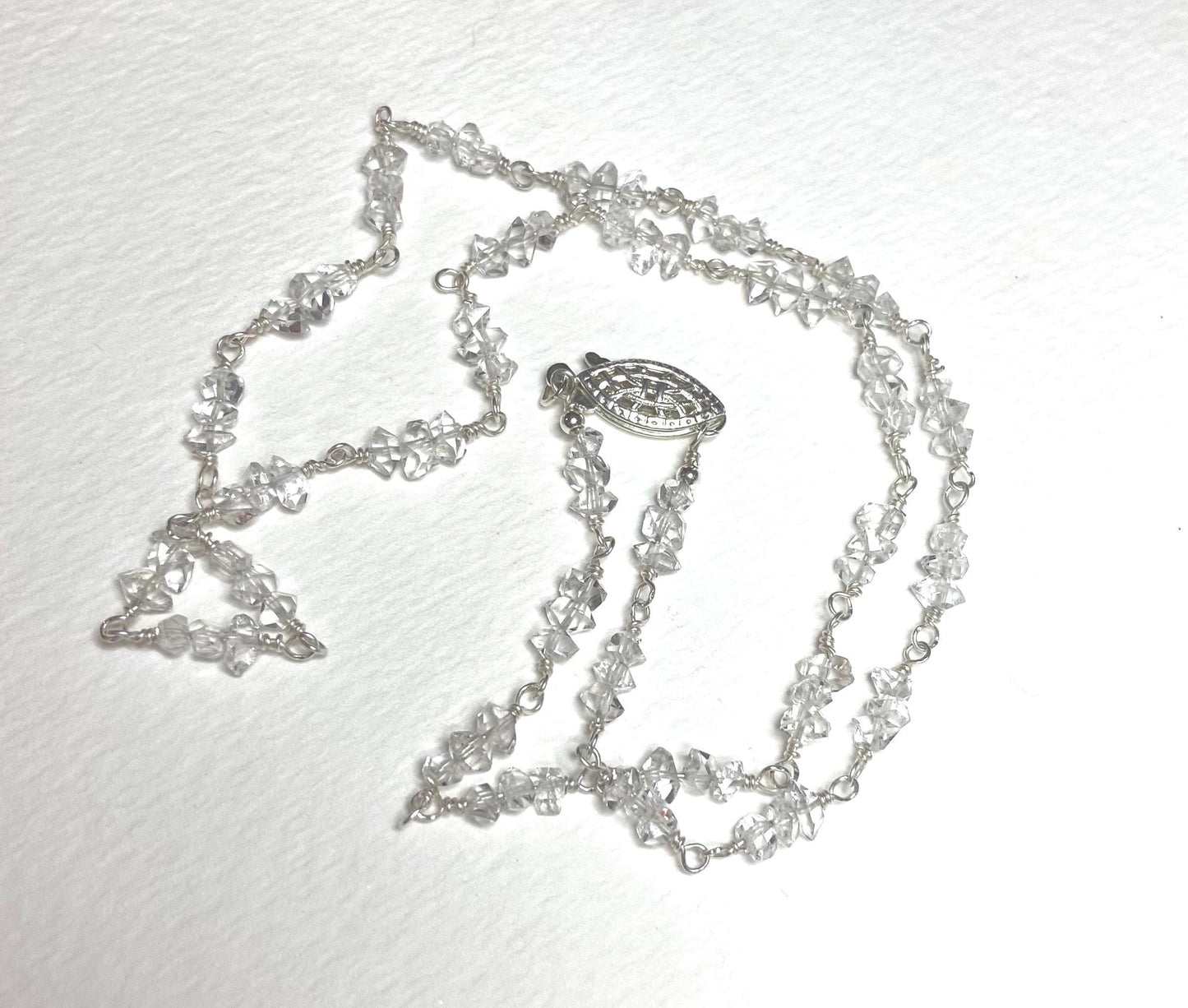 Sterling silver necklace with double terminated quartz crystals and a filigree clasp.