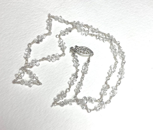 Sterling silver necklace with double terminated quartz crystals and a filigree clasp.