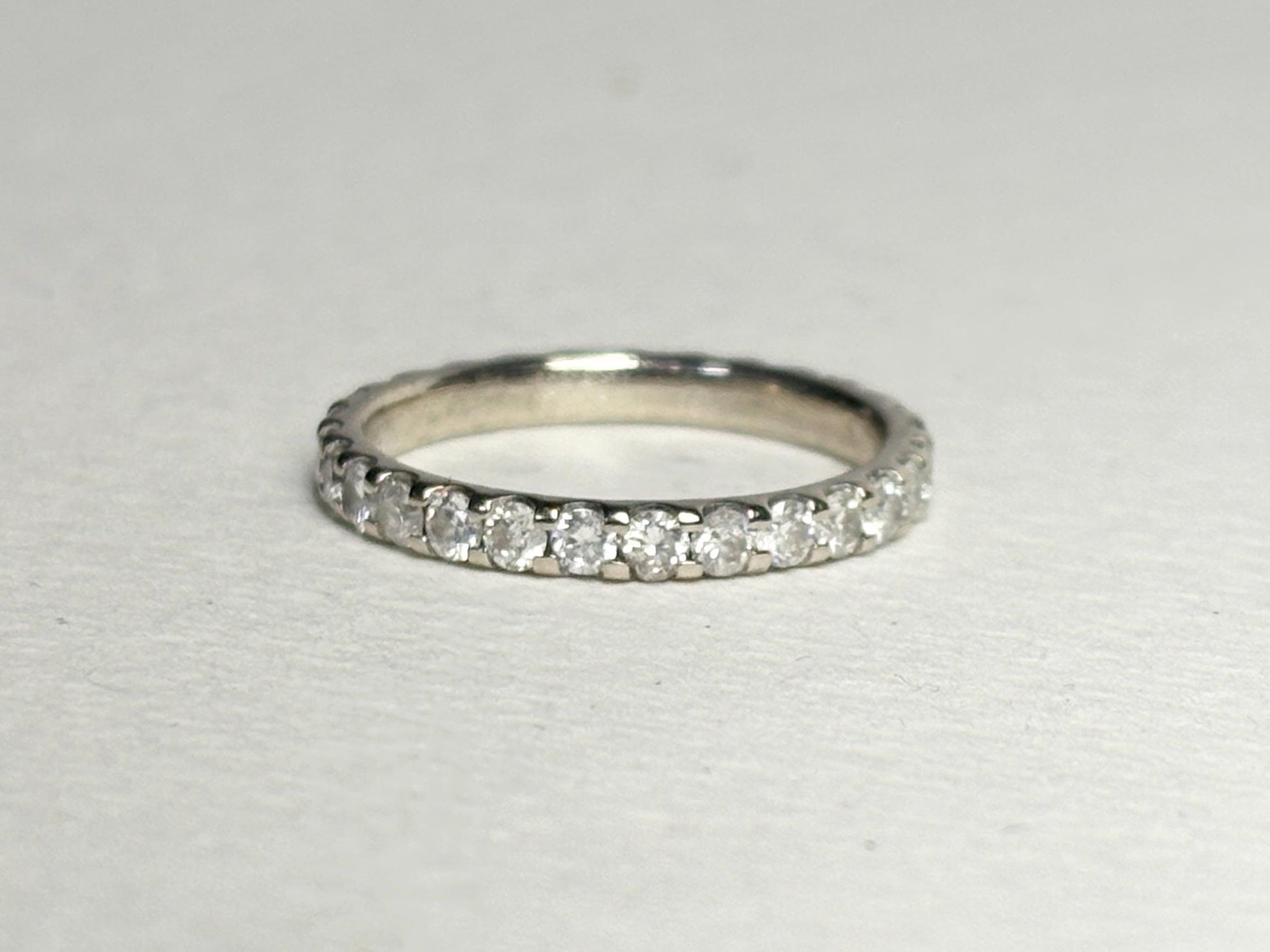 14k white gold full eternity band with 1ctw diamonds.