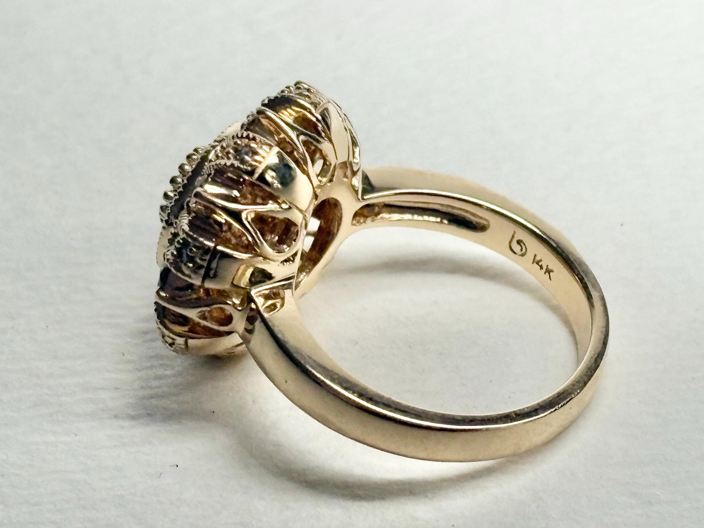 A bold 14k gold ring with a sunburst style setting featuring natural champagne diamonds.