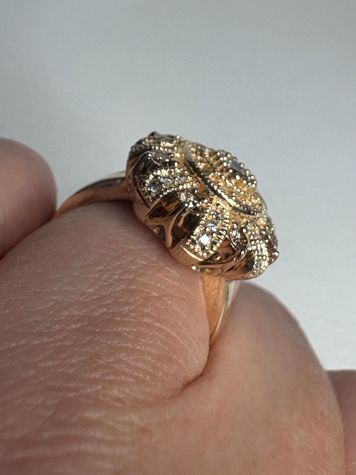 A 14k gold sunburst ring with champagne diamonds.