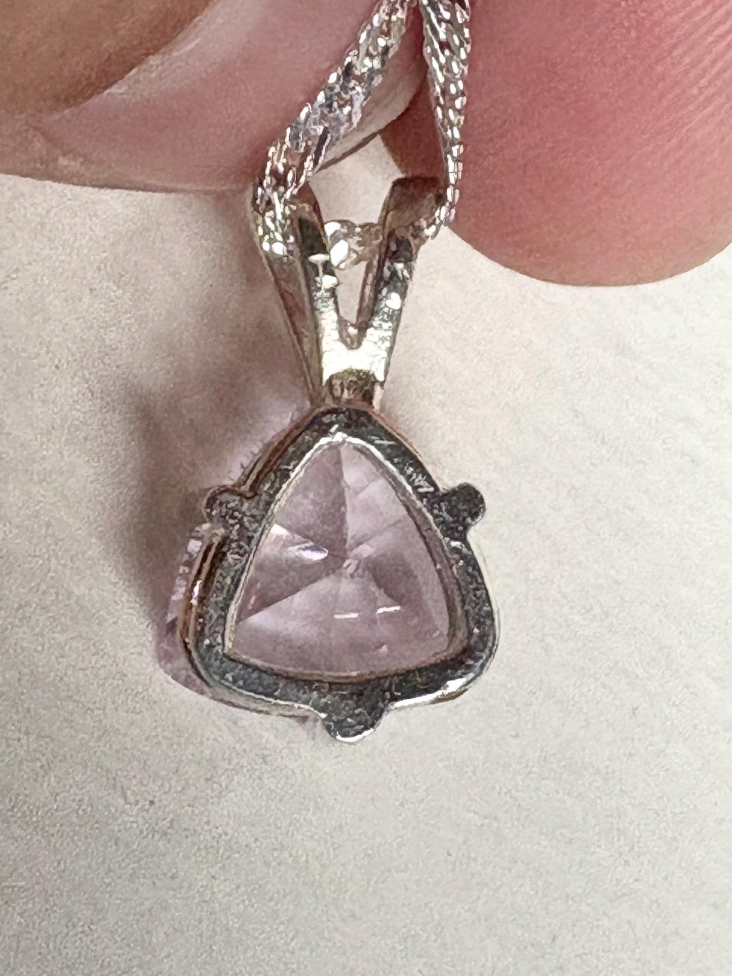 Sterling silver pendant necklace with a trillion-cut kunzite gemstone.