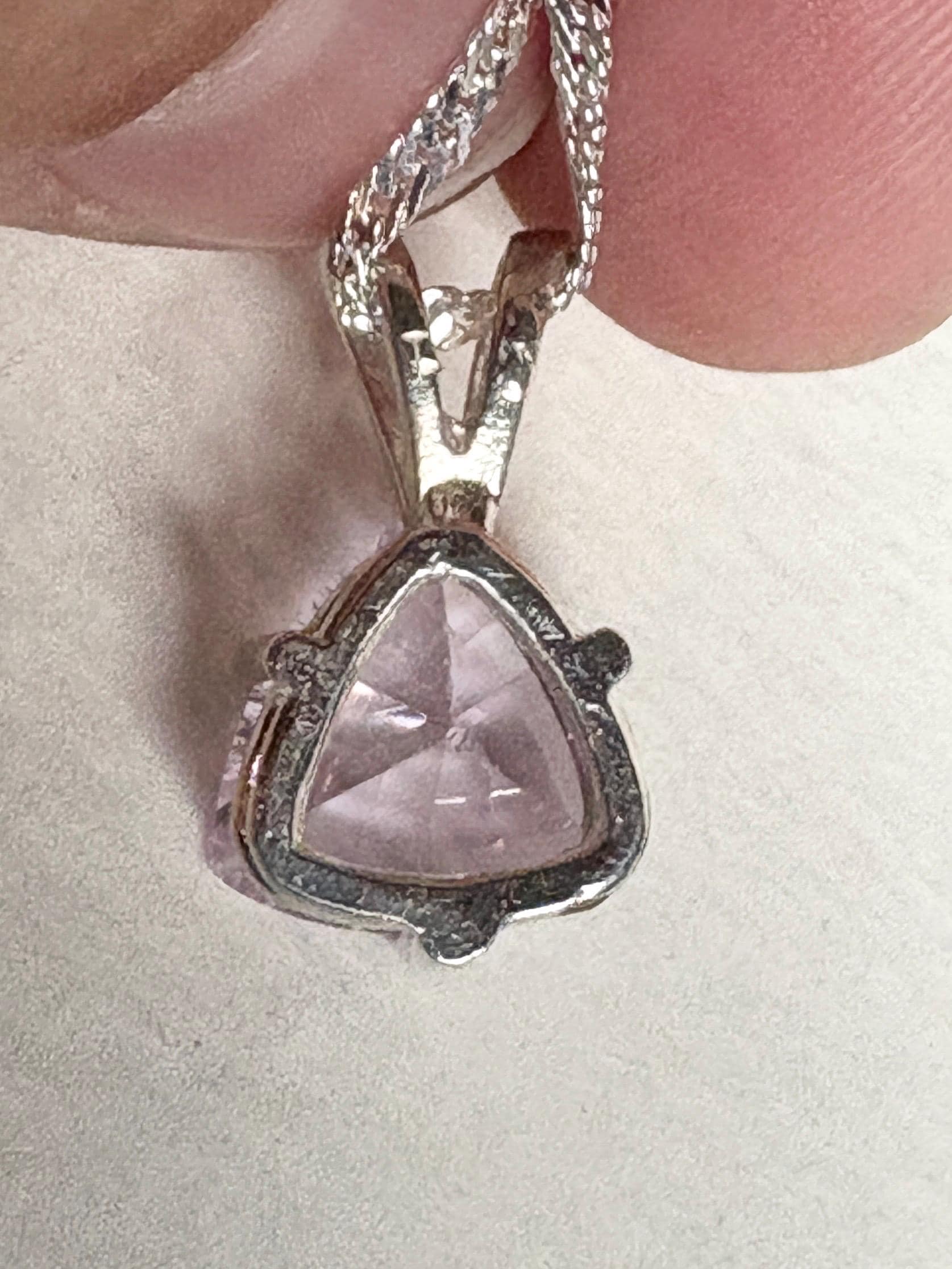 Sterling silver pendant necklace with a trillion-cut kunzite gemstone.
