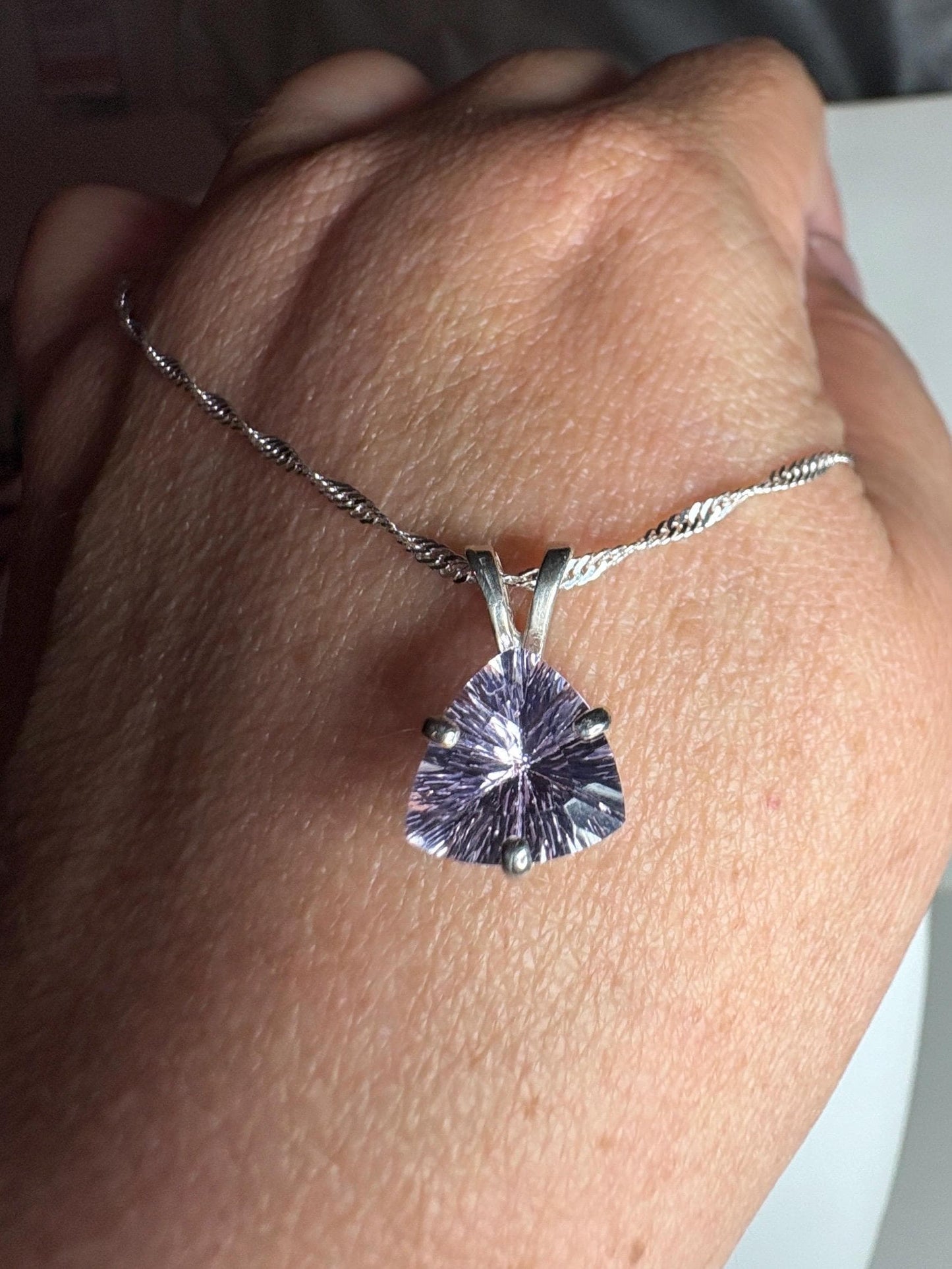 Sterling silver pendant necklace with a trillion-cut kunzite gemstone.