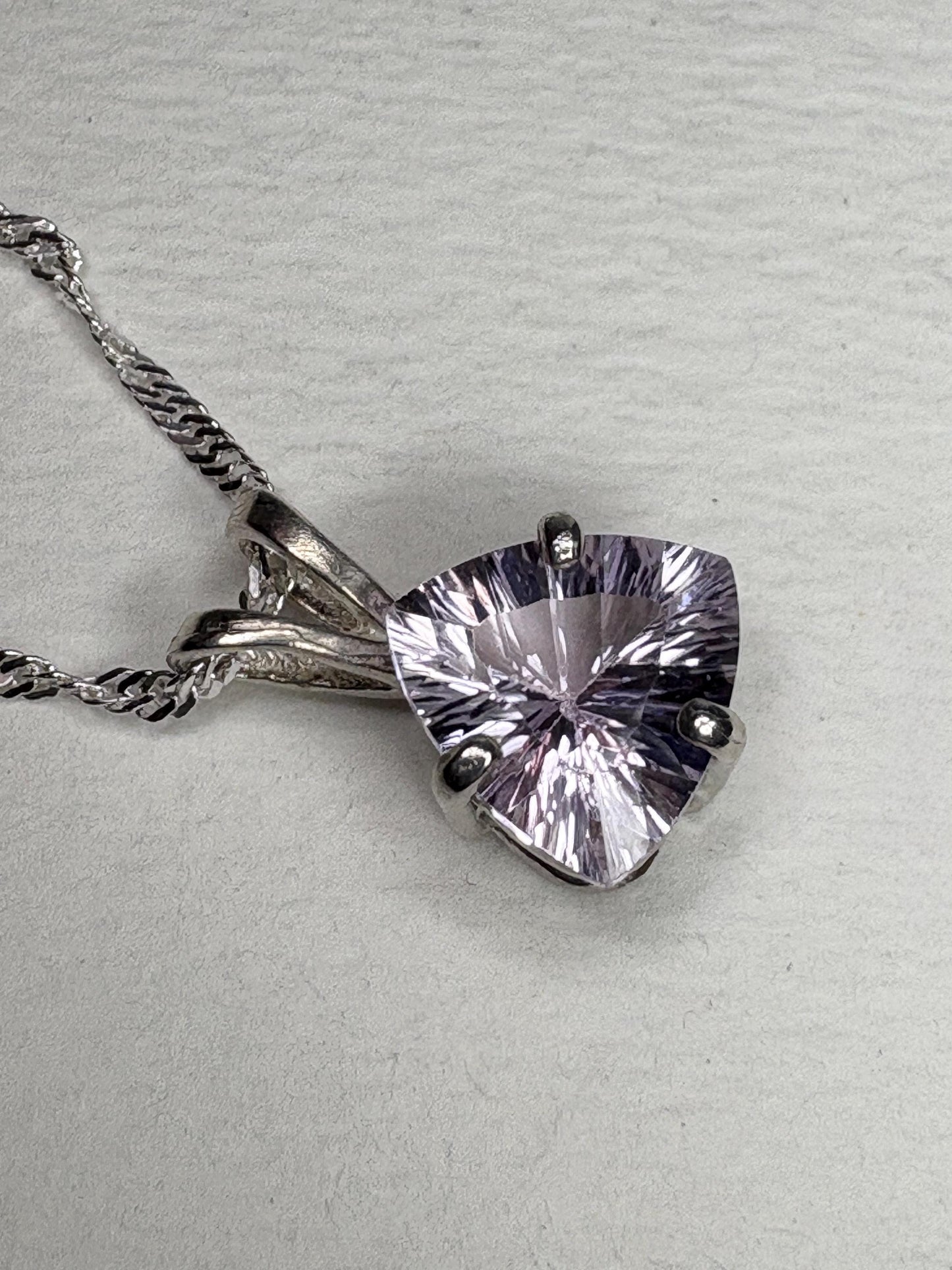 Sterling silver pendant necklace with a light lilac trillion kunzite gemstone.