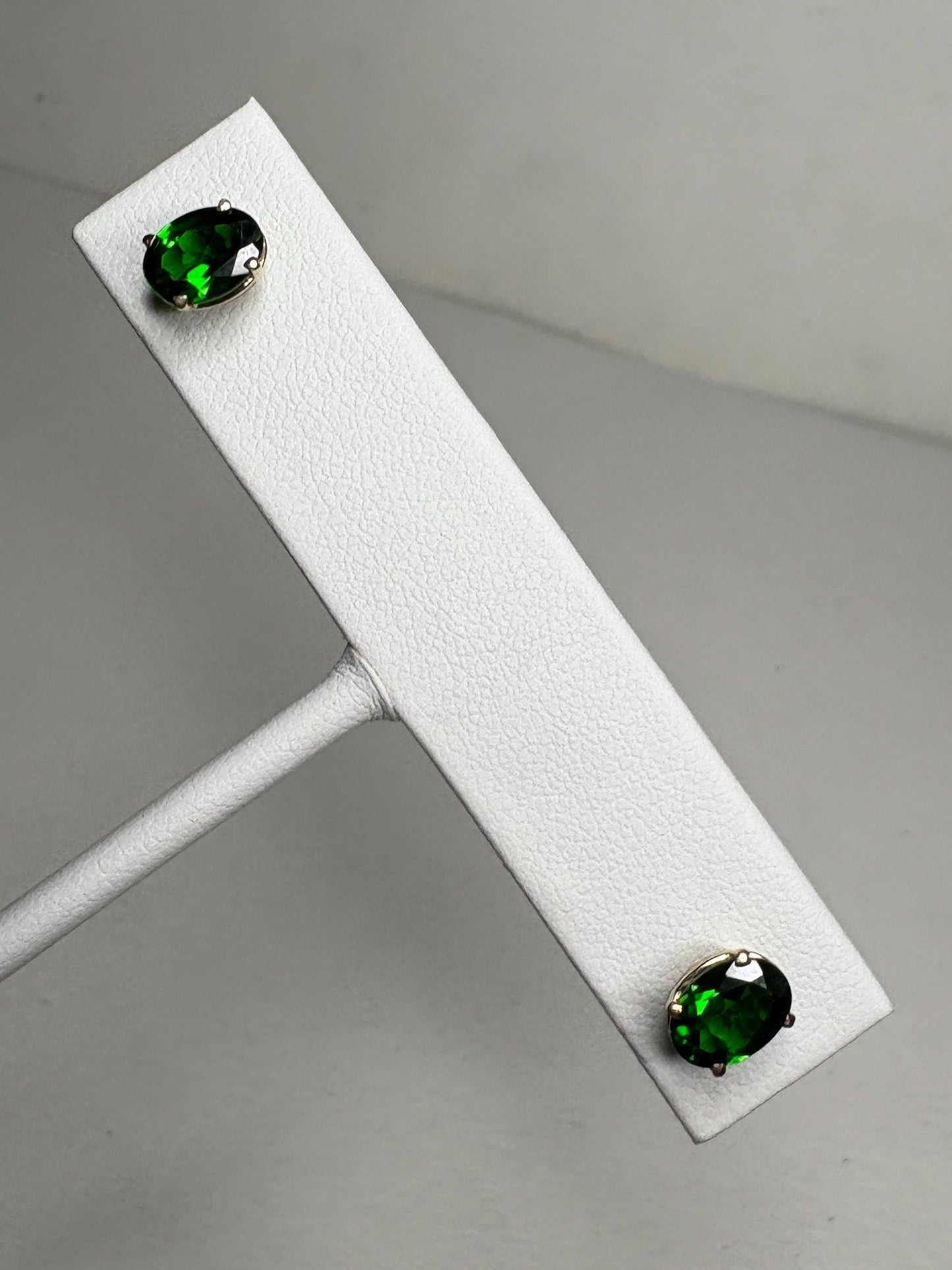 Oval chrome diopside stud earrings in 14k gold.