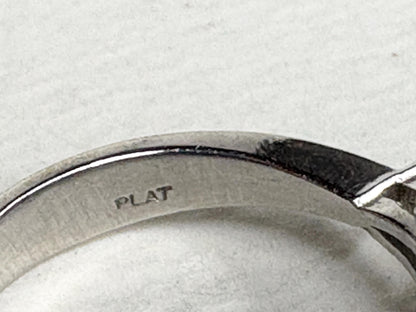 Platinum ring with "PLAT" stamp and a pink sapphire.