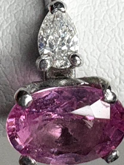 Platinum ring with oval pink sapphire and pear diamonds.