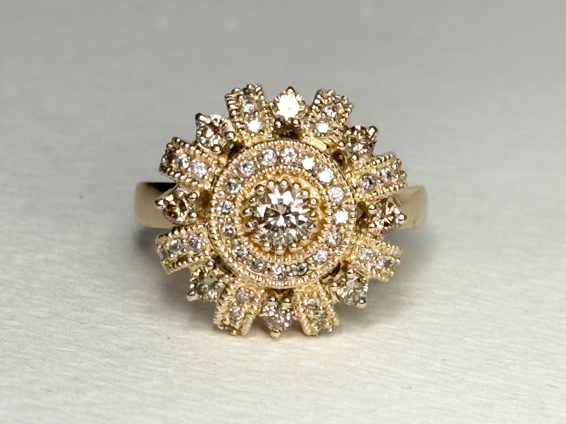 A 14k gold sunburst ring with champagne diamonds.
