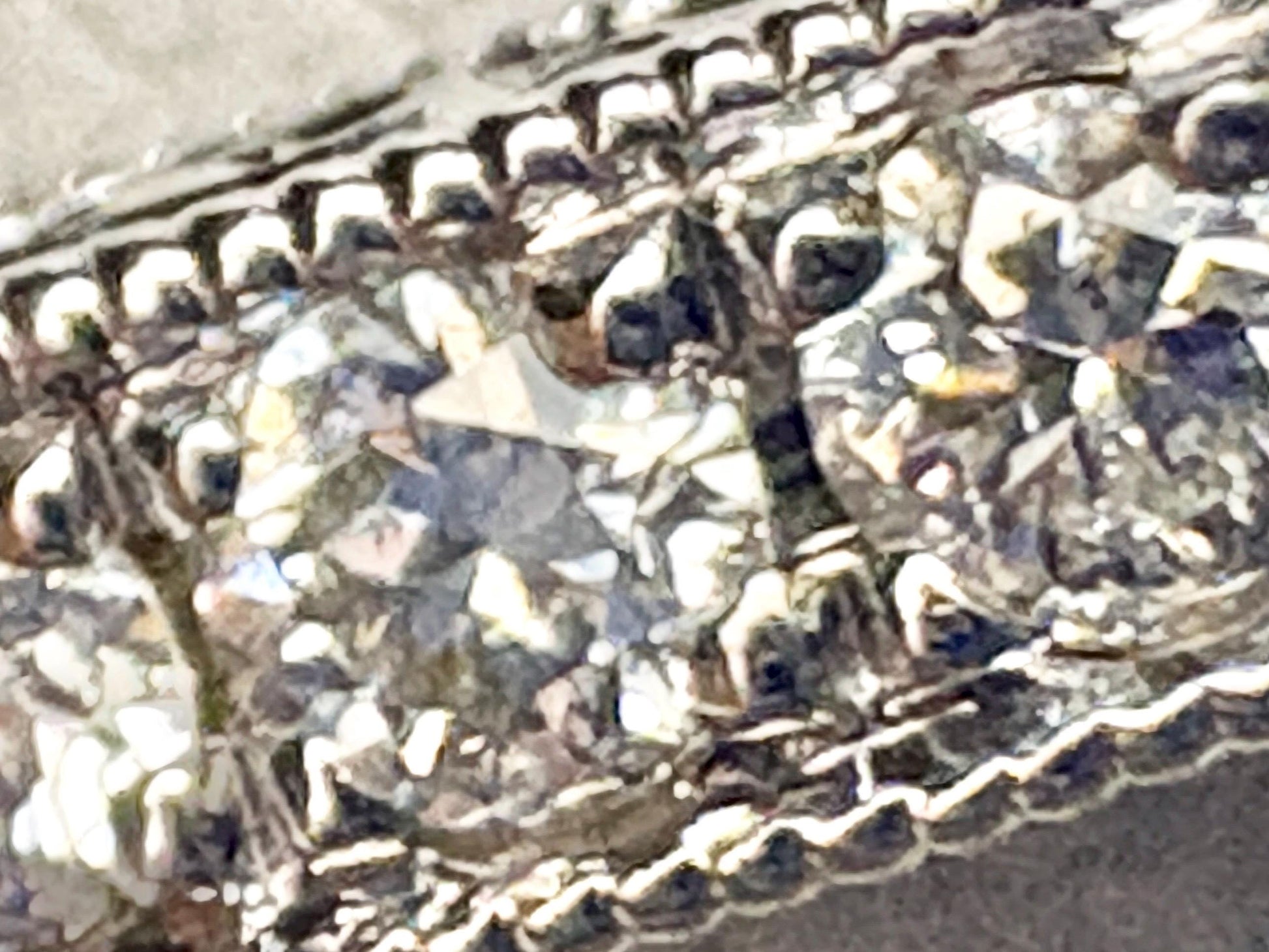 A 14k white gold band ring with .56 ctw of natural diamonds and detailed etching.