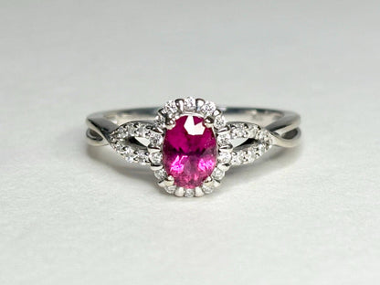 Oval rubellite tourmaline and diamond halo ring in 10k white gold.