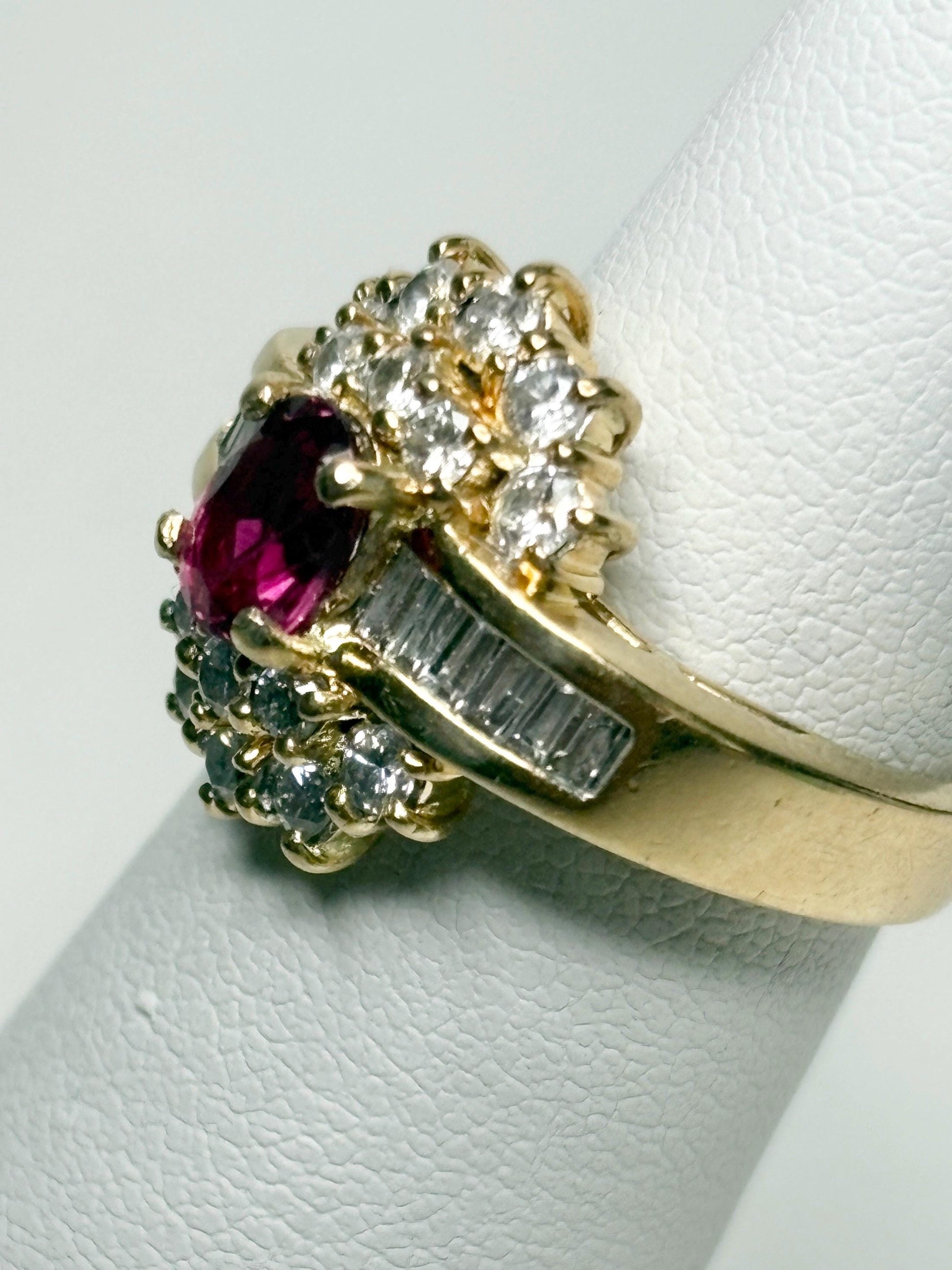 18k gold ring with ruby and diamond accents.