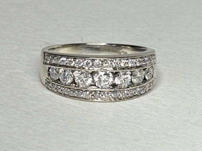 A 14k white gold anniversary band ring with channel and pave set diamonds.