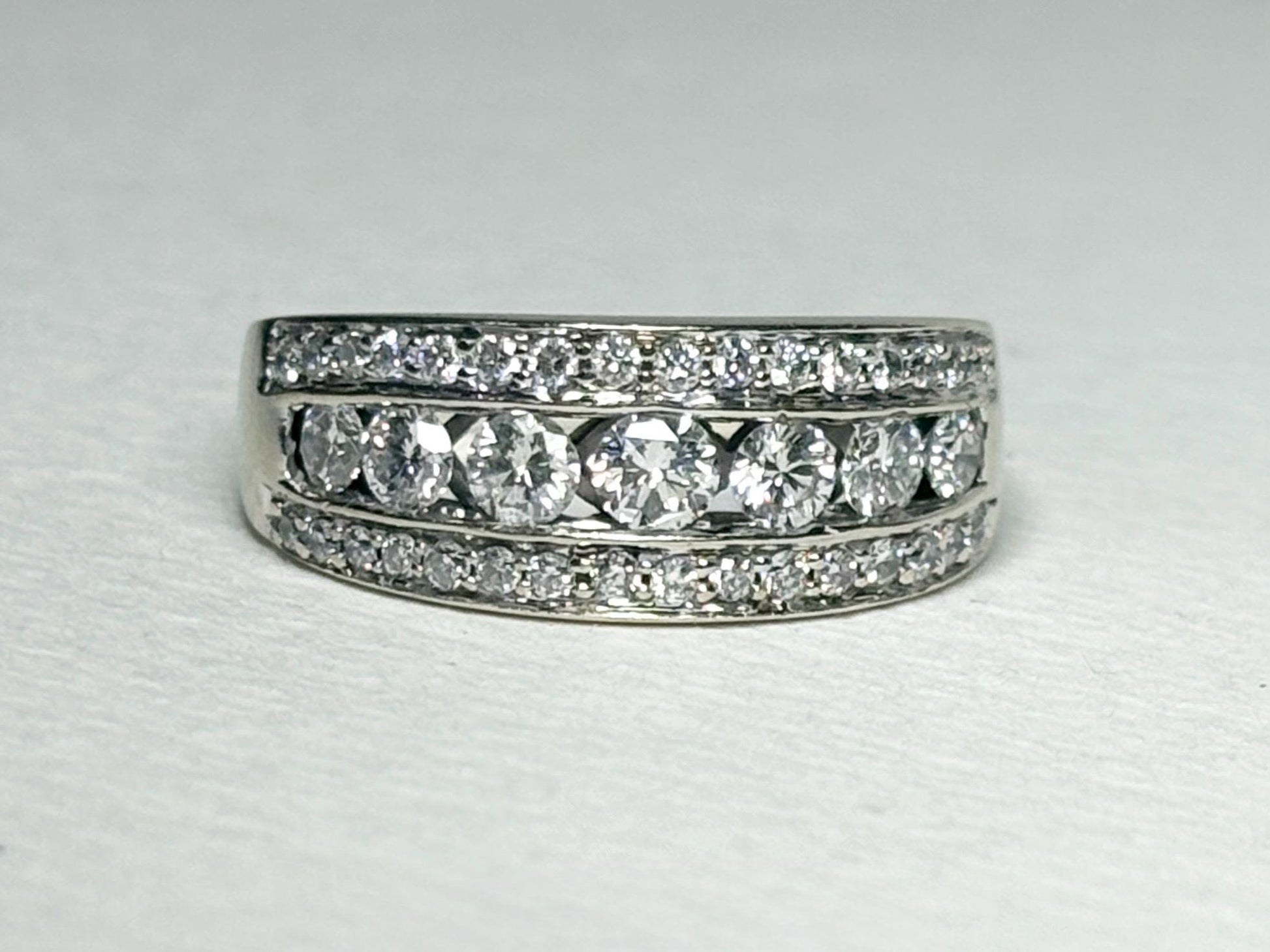 A 14k white gold anniversary ring with channel and pave set diamonds.