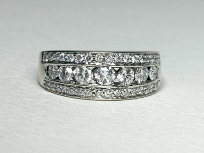 A 14k white gold anniversary ring with channel and pave set diamonds.