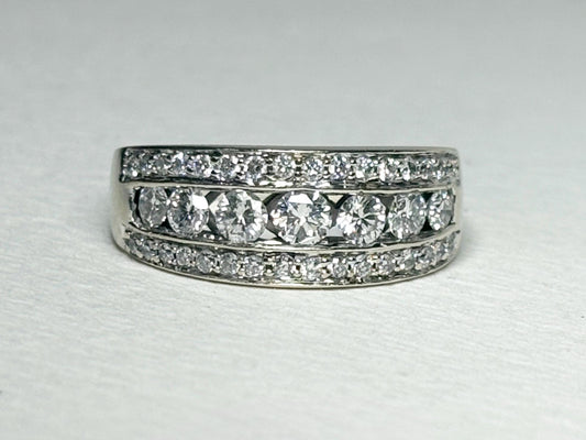 A 14k white gold anniversary ring with channel and pave set diamonds.
