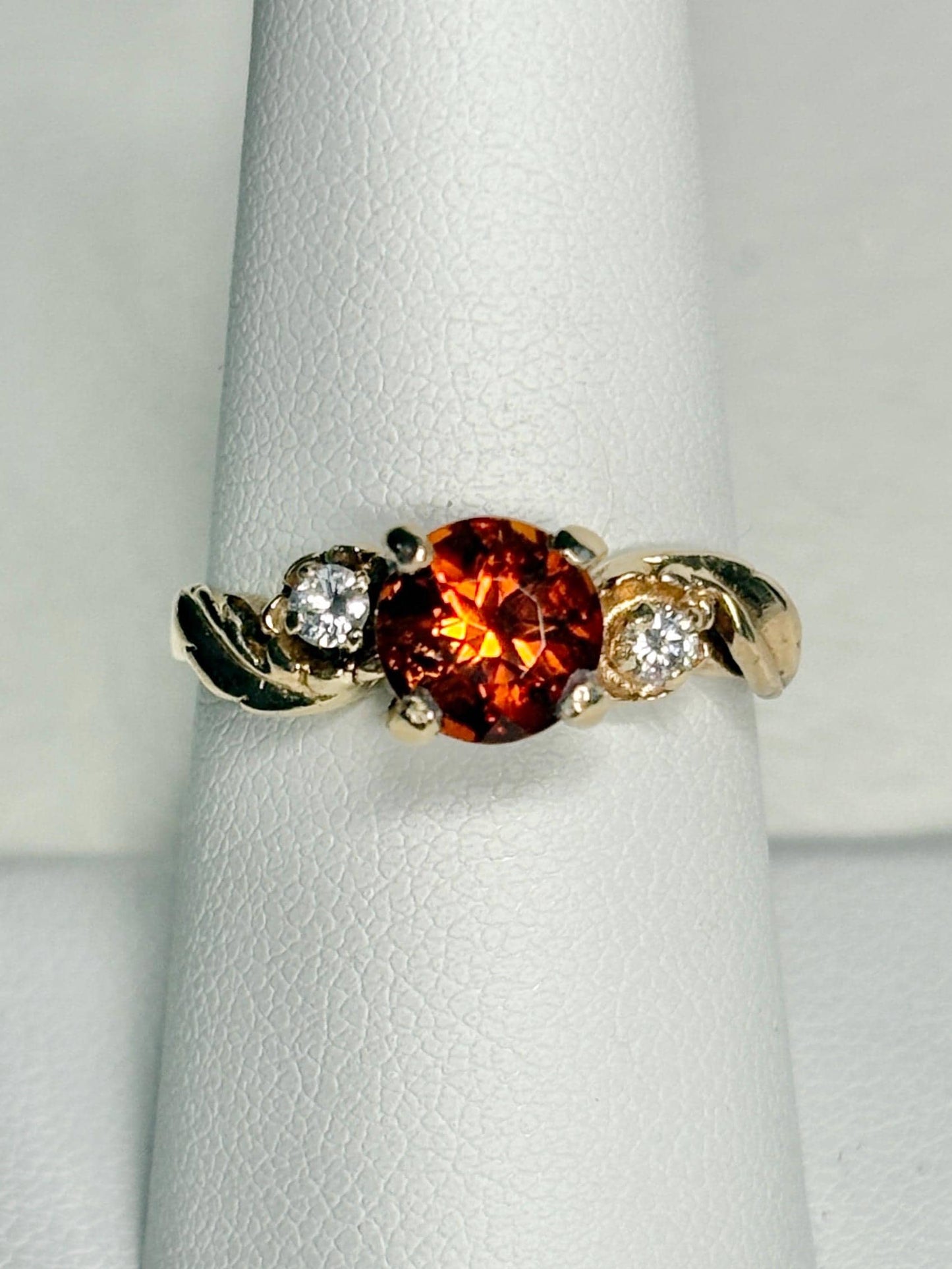 14k gold ring with a Madeira citrine and two diamonds in a floral design.