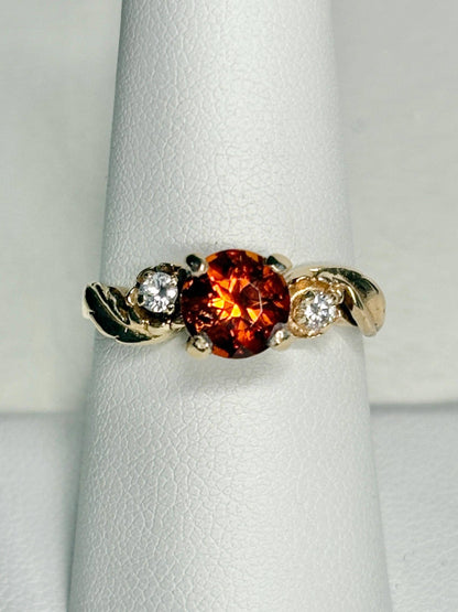 14k gold ring with a Madeira citrine and two diamonds in a floral design.