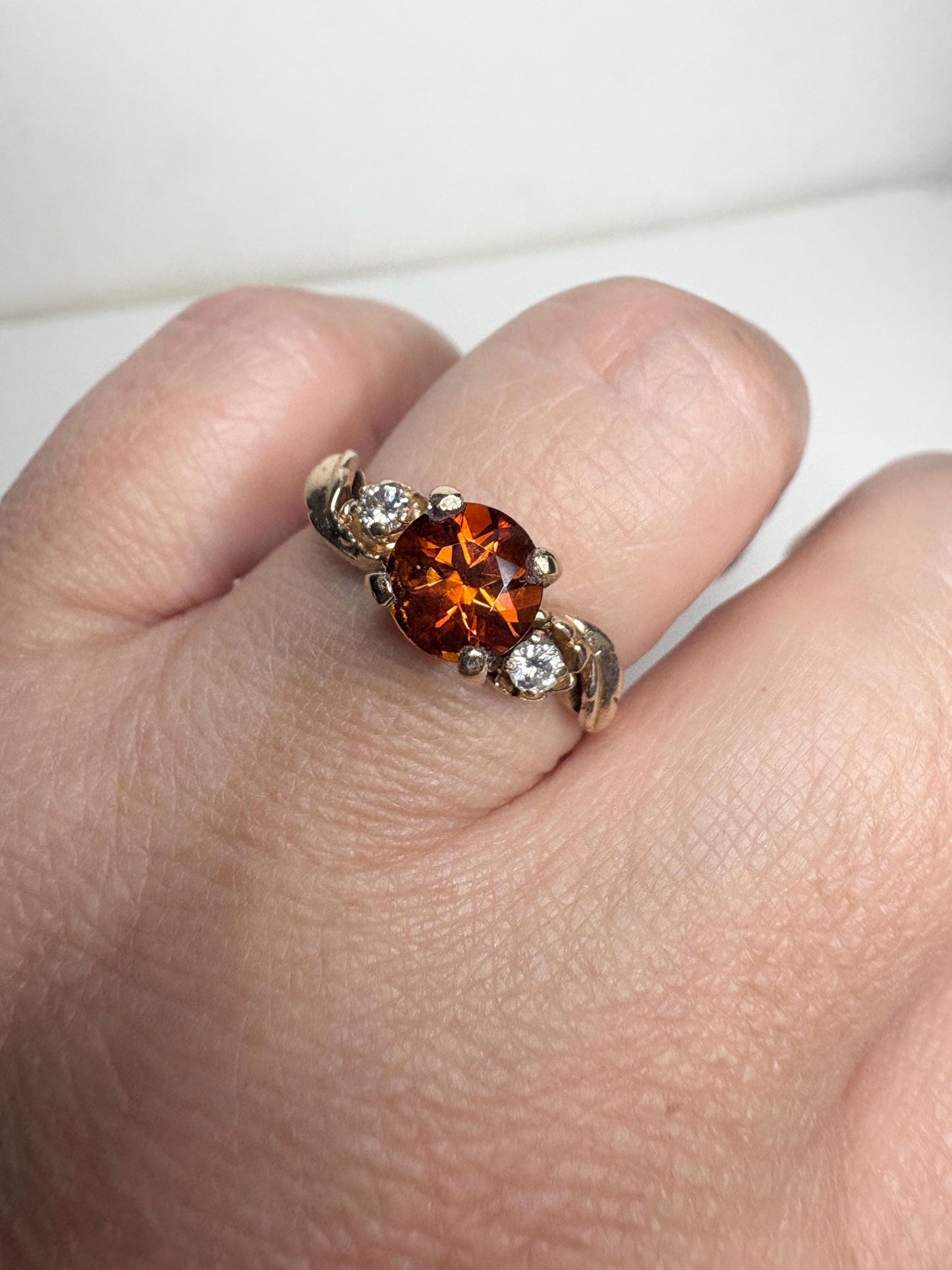 14k gold ring with a Madeira citrine and two diamonds in a floral design.