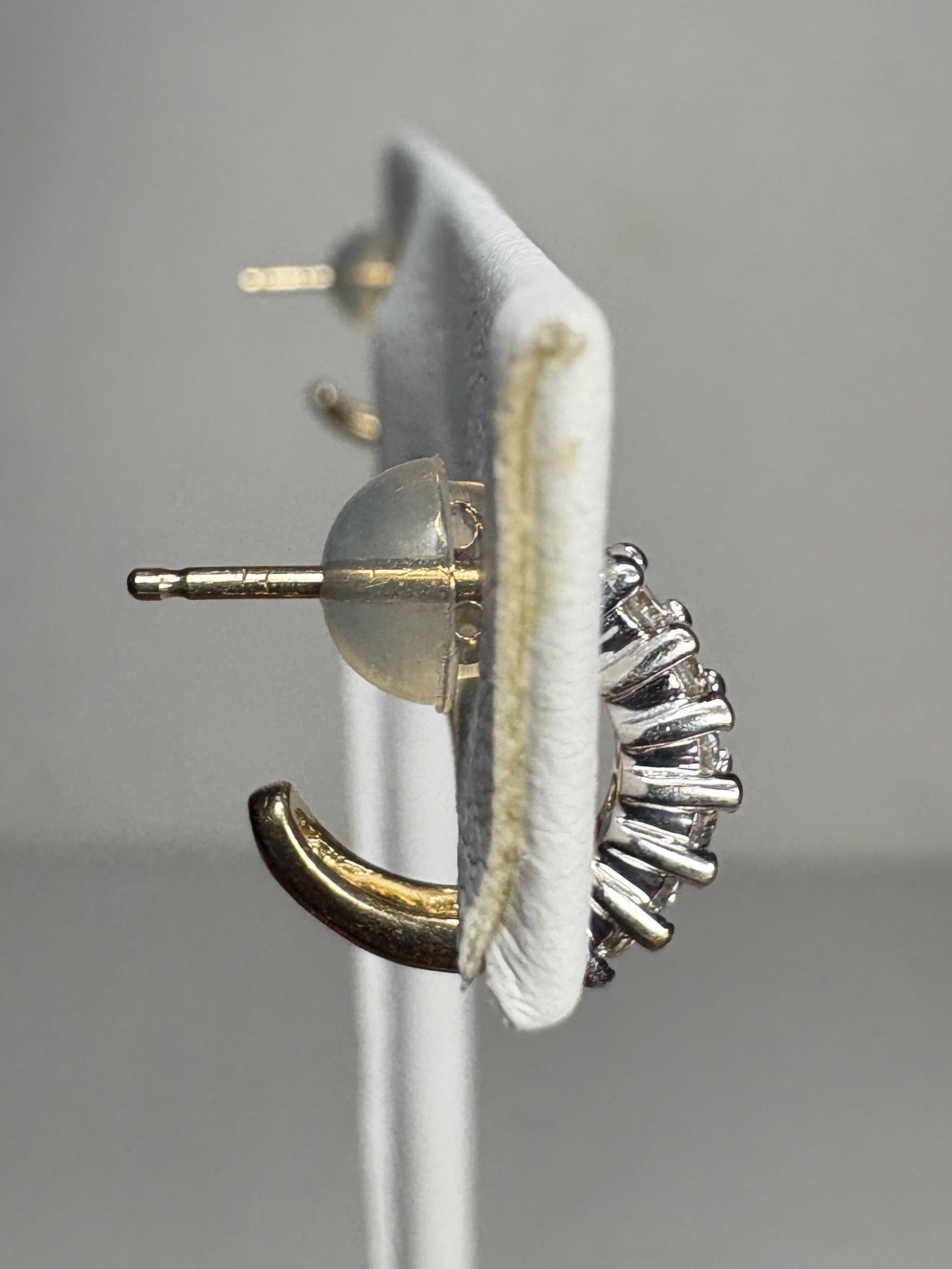 Tiny 14k gold partial hoop stud earrings with natural diamonds.