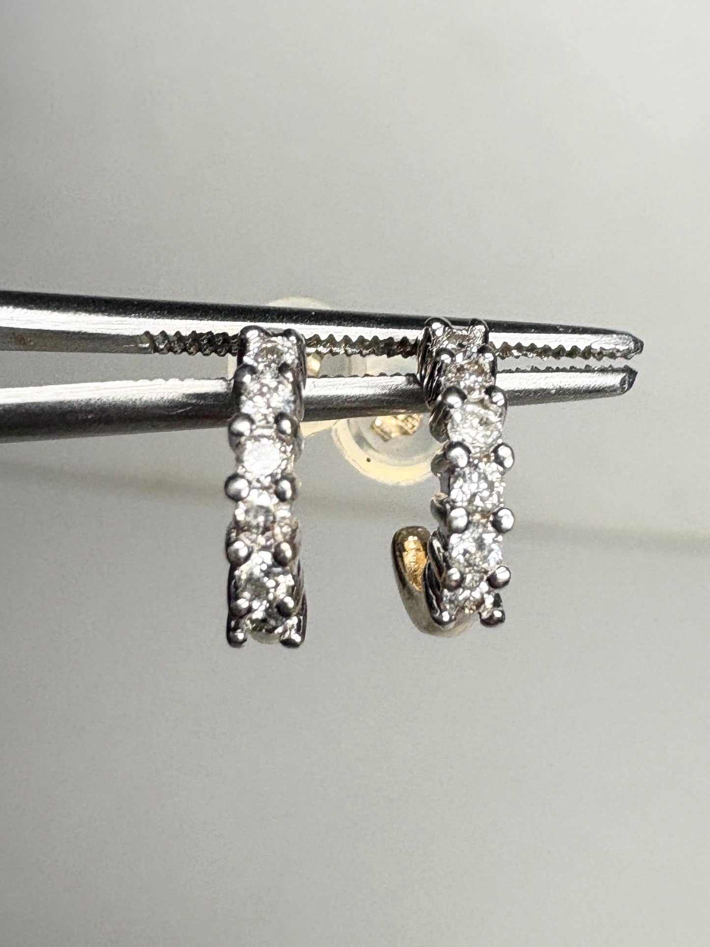 Tiny 14k gold hoop earrings with natural diamonds.