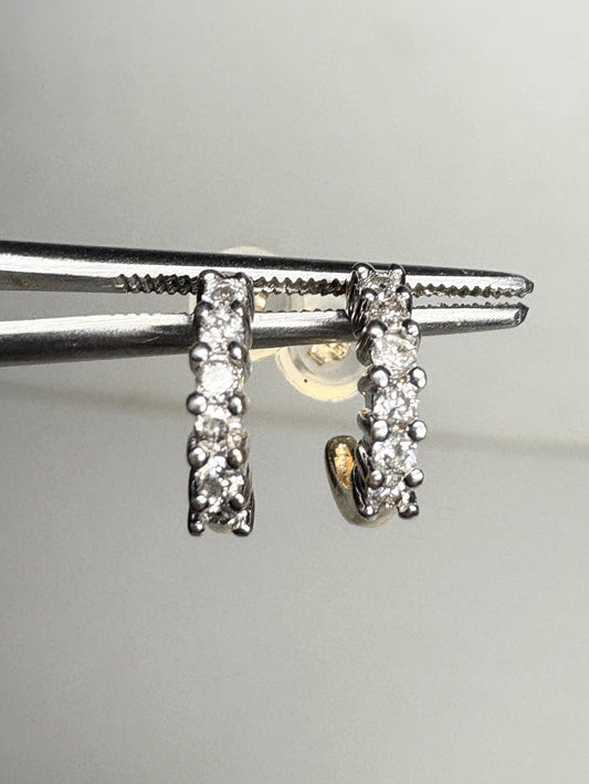 Tiny 14k gold hoop earrings with natural diamonds.