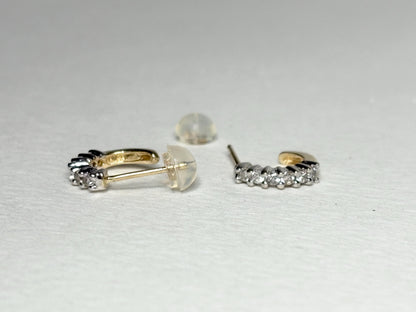 Tiny 14k gold hoop earrings with natural diamonds and silicone backs.
