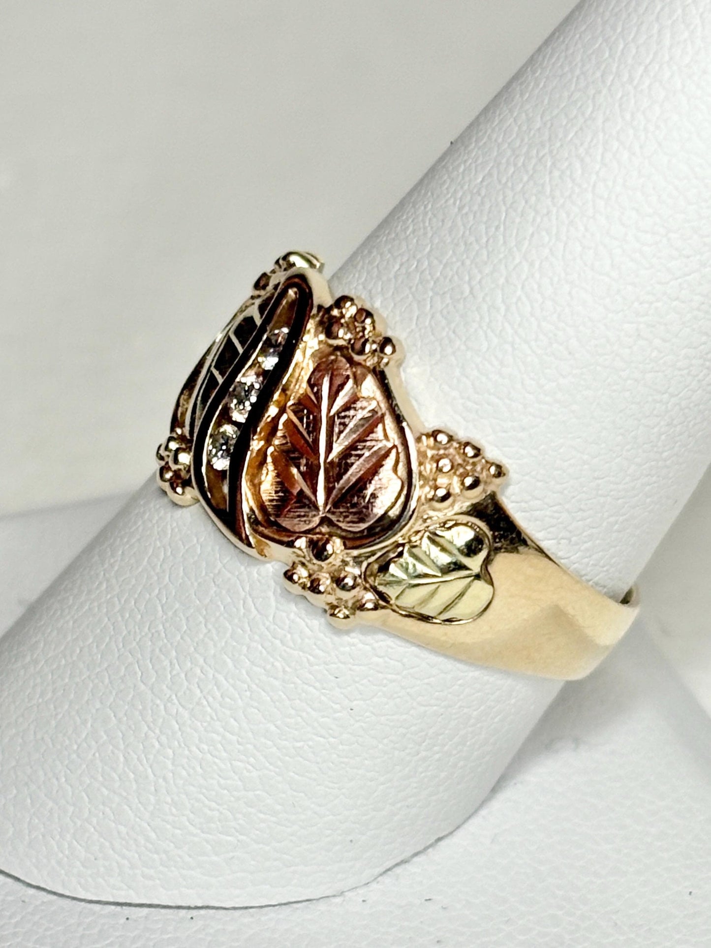 Black Hills Gold ring with diamonds and tri-color leaves.