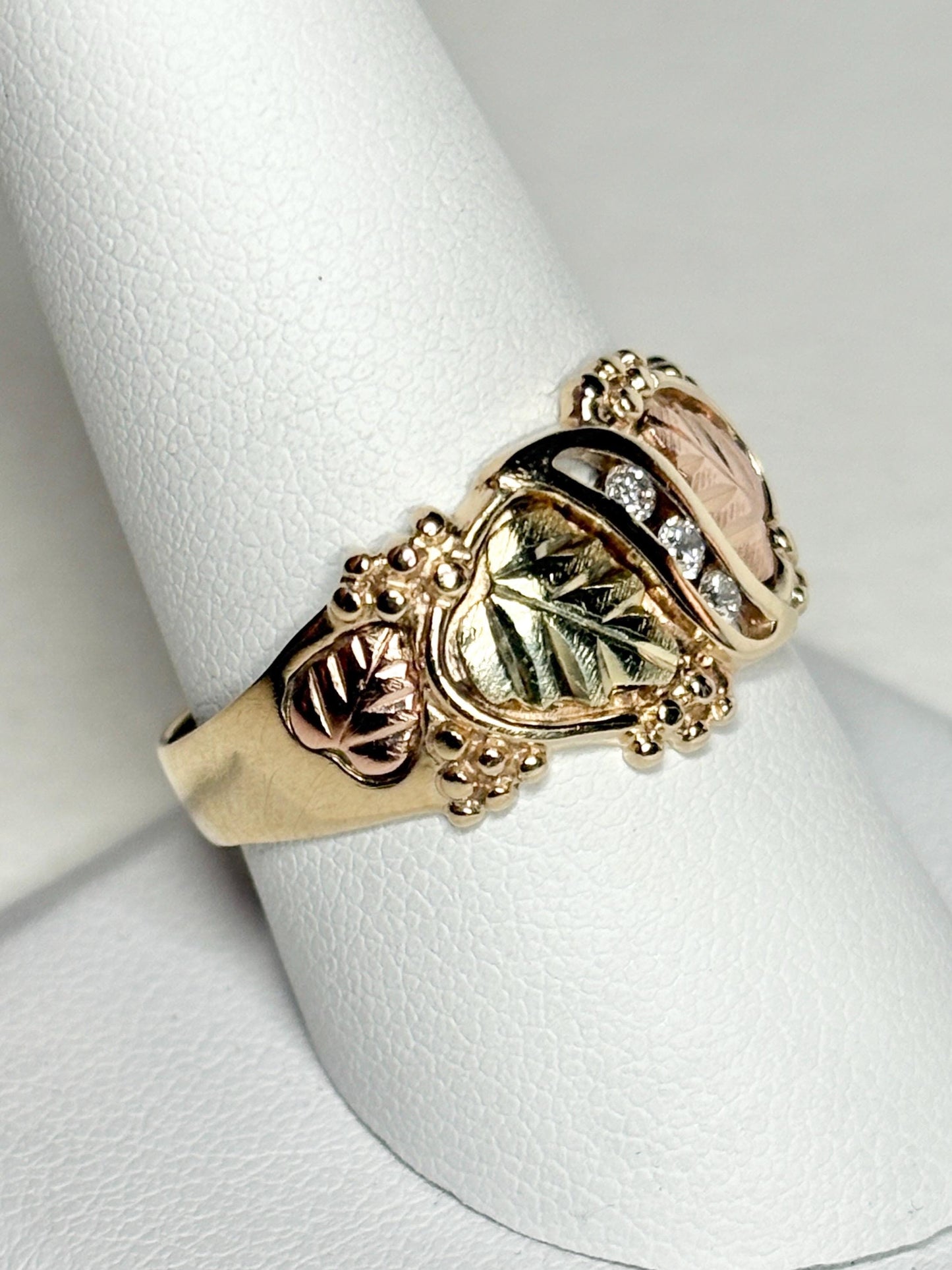 Black Hills Gold ring with diamonds and tri-color gold leaves.