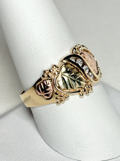 Black Hills Gold ring with diamonds and tri-color gold leaves.