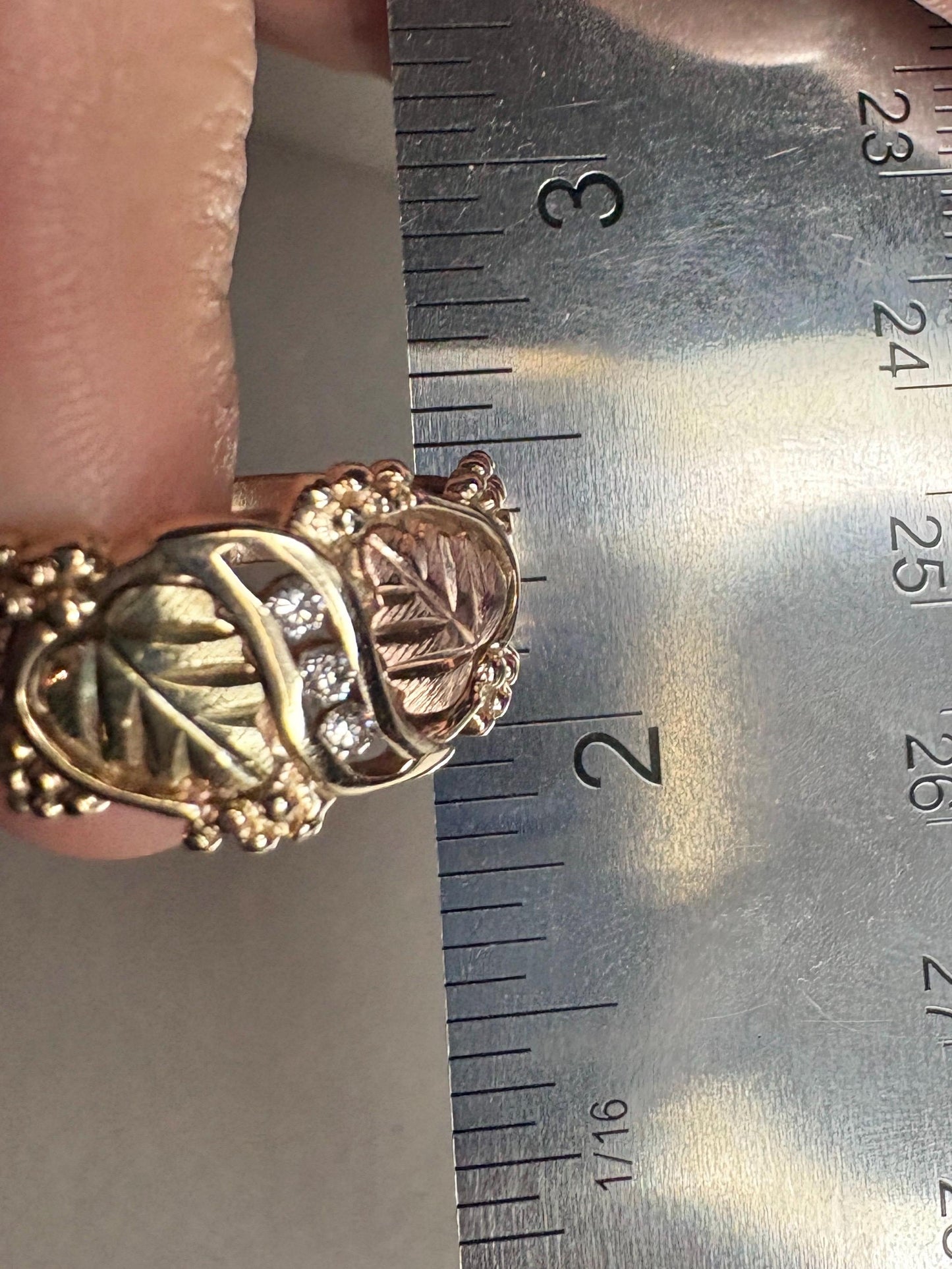 A size 9.75 solid 10k tri-color gold ring with Black Hills Gold leaf design and three diamonds.