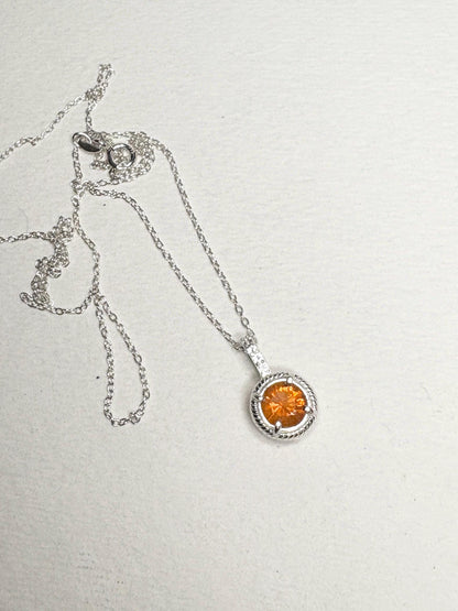 Sterling silver necklace with an orange fire opal and white topaz pendant.