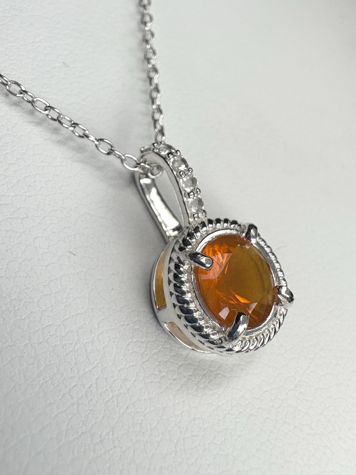 Sterling silver pendant necklace with Oregon fire opal and white topaz accents.