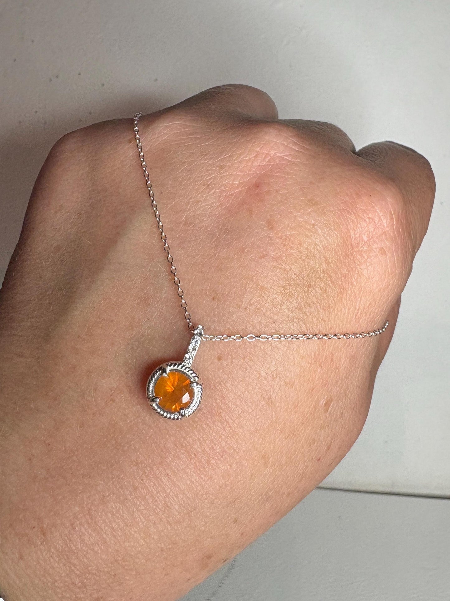 Sterling silver necklace with a round Oregon fire opal pendant and white topaz accents.