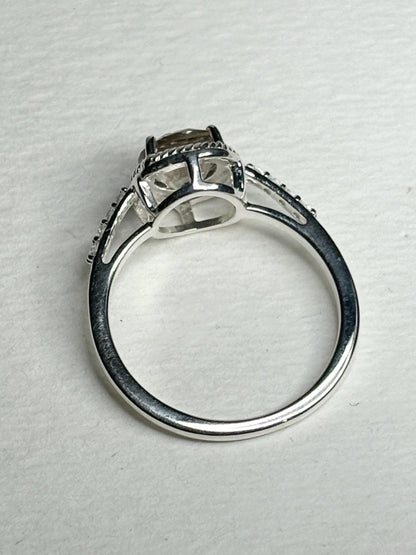 Sterling silver ring with a light peach Oregon sunstone, white topaz accents, and rope design.