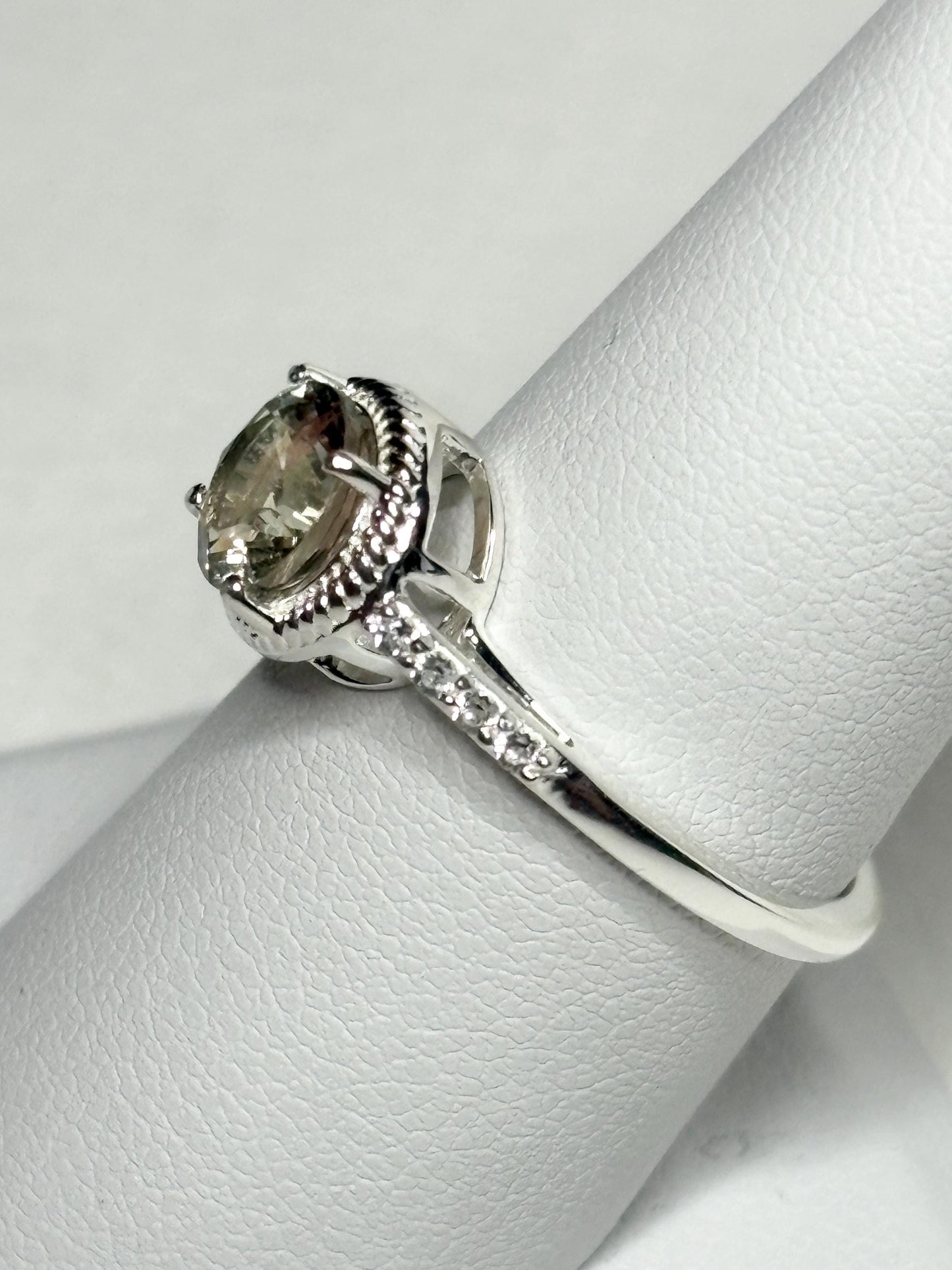 Sterling silver ring with a round Oregon sunstone and white topaz accents.