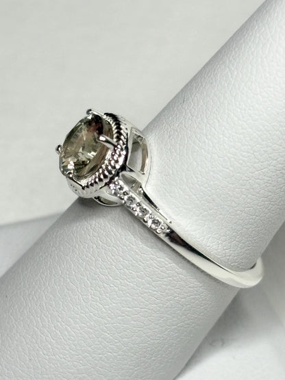 Sterling silver ring with a round Oregon sunstone and white topaz accents.