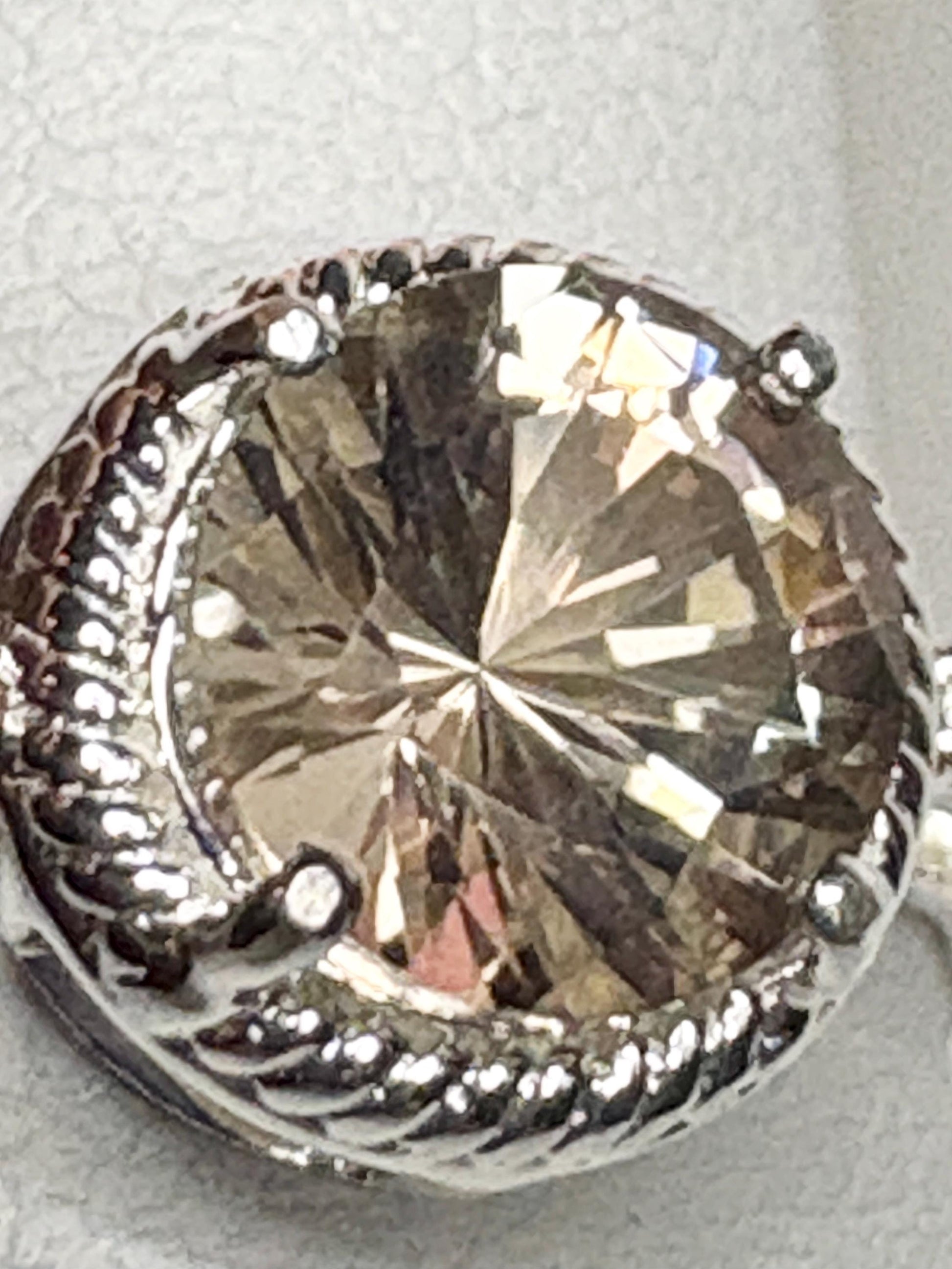 Sterling silver ring with a round Oregon sunstone and white topaz accents.