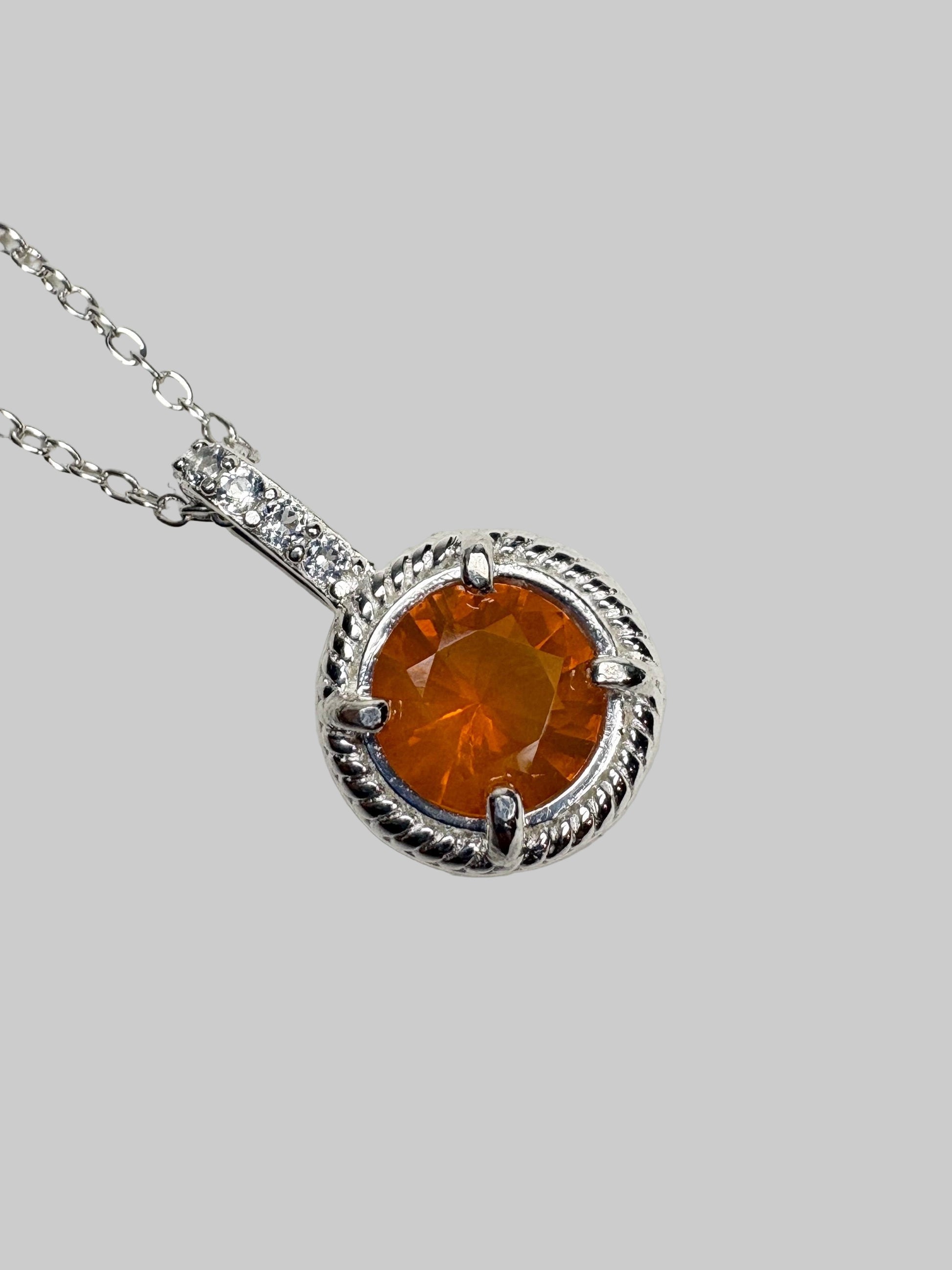 Sterling silver pendant necklace with Oregon fire opal and white topaz accents.