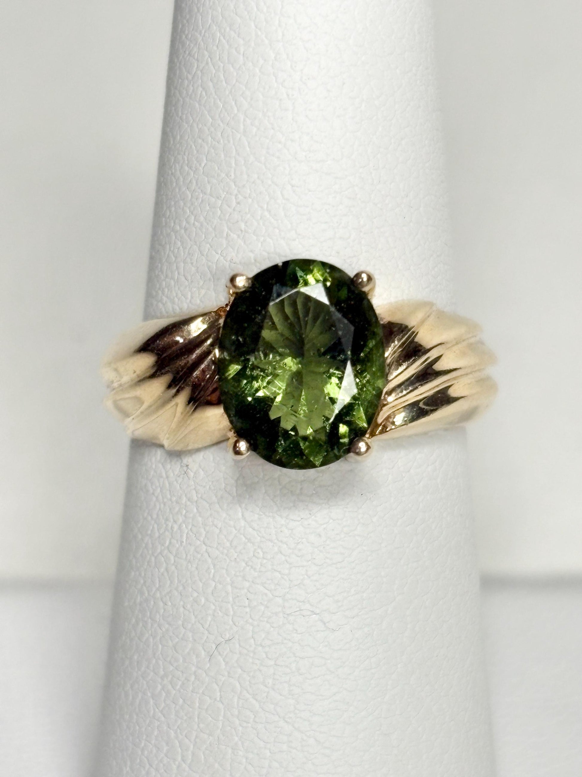 Oval faceted moldavite ring in solid 14k gold.