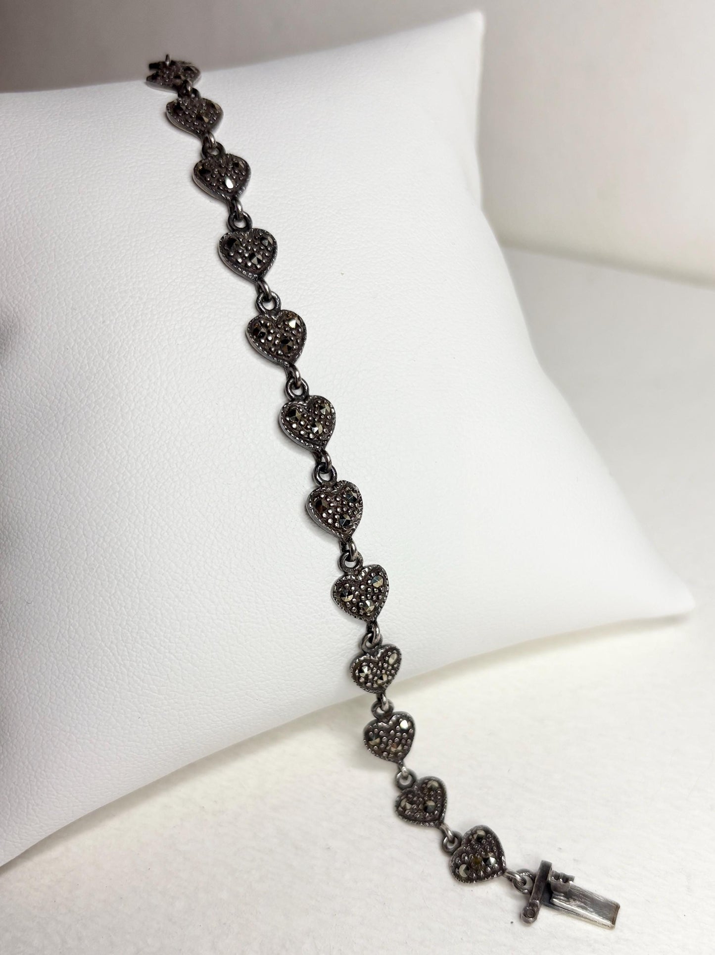 Oxidized sterling silver bracelet with marcasite-studded heart links.