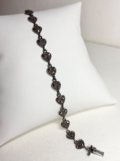 Oxidized sterling silver bracelet with marcasite-studded heart links.