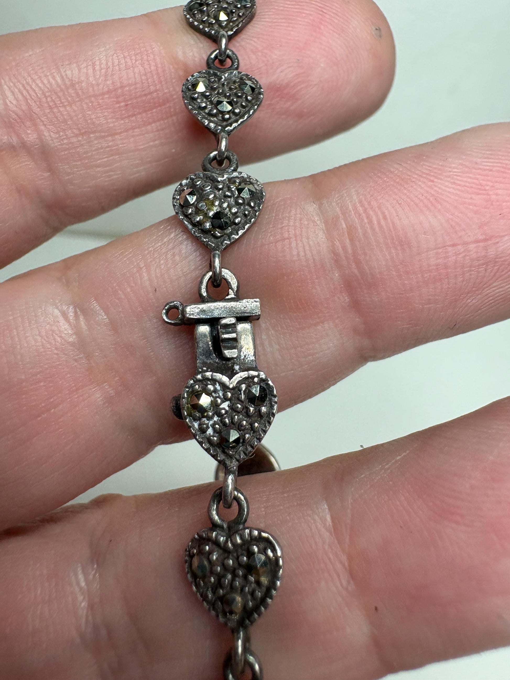 Sterling silver bracelet with oxidized marcasite heart links and a secure clasp.