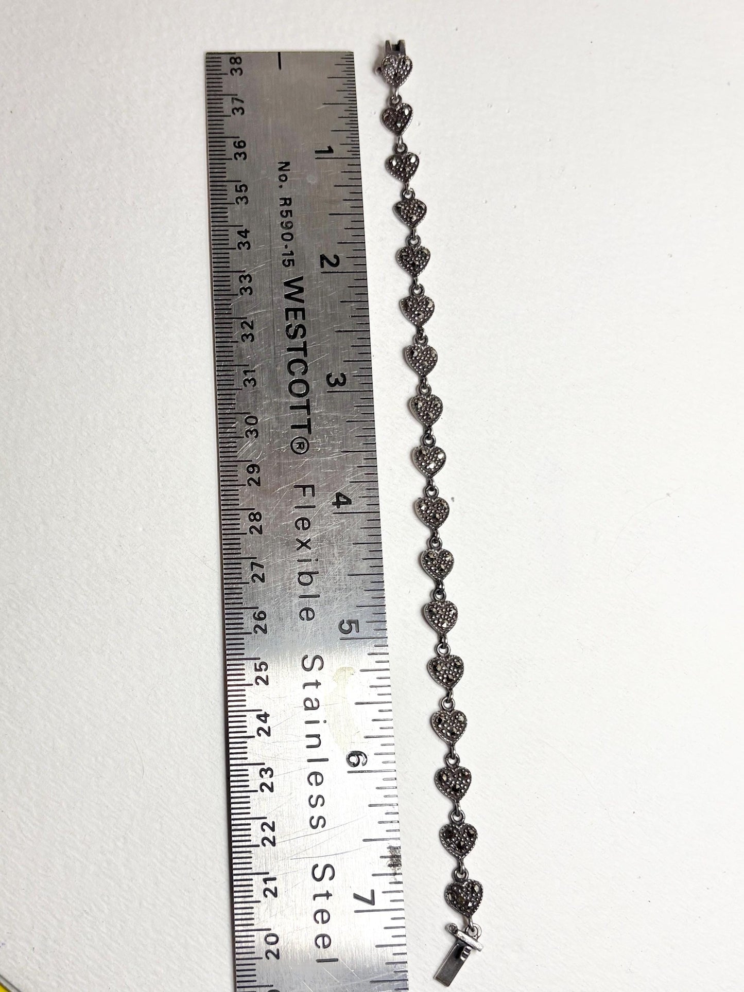 Sterling silver bracelet with marcasite heart links, measuring 7.25 inches.