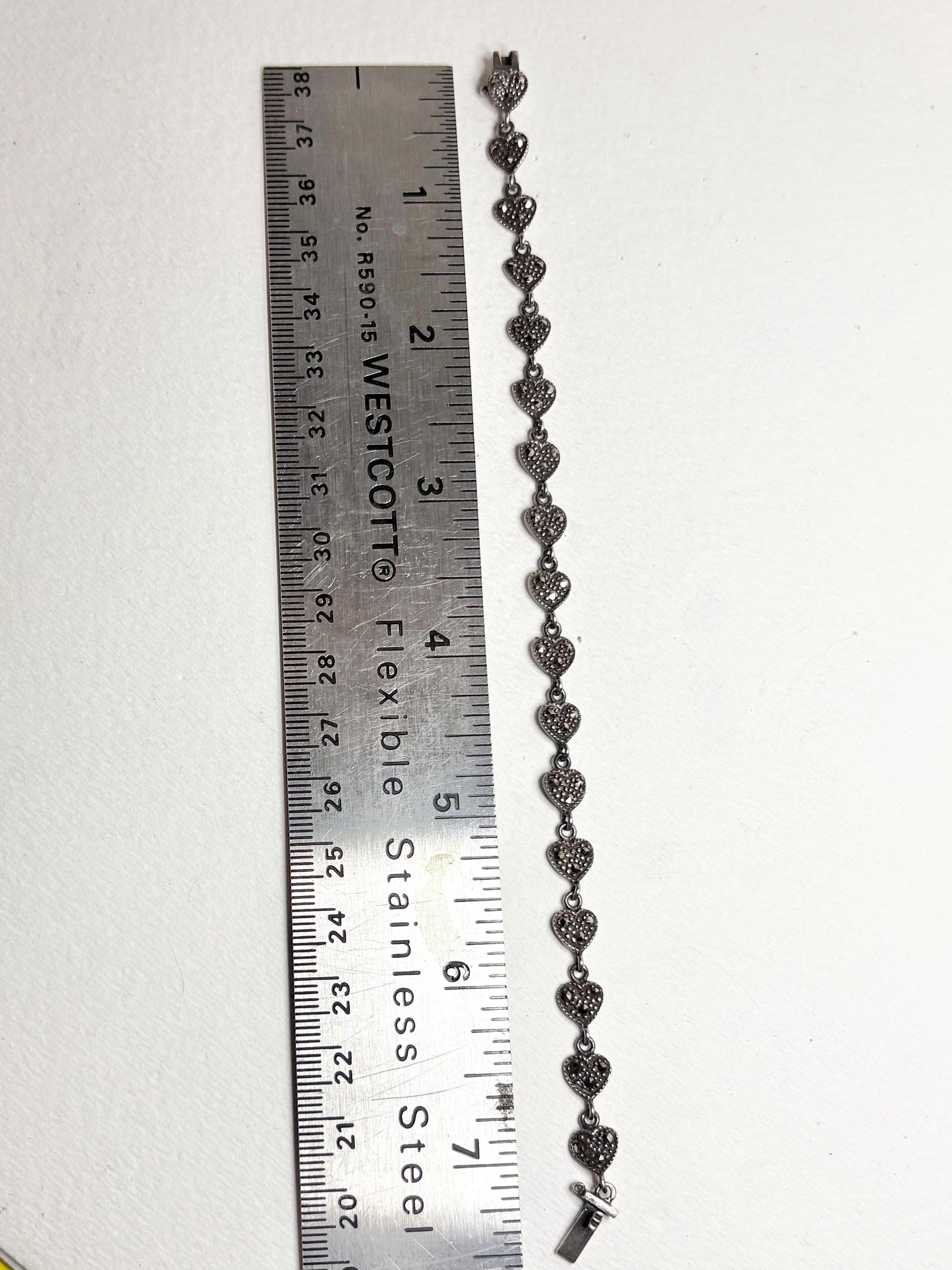 Sterling silver bracelet with marcasite heart links, measuring 7.25 inches.