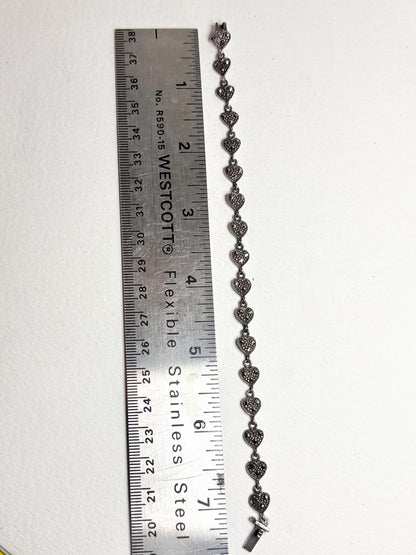 Sterling silver bracelet with marcasite heart links, measuring 7.25 inches.