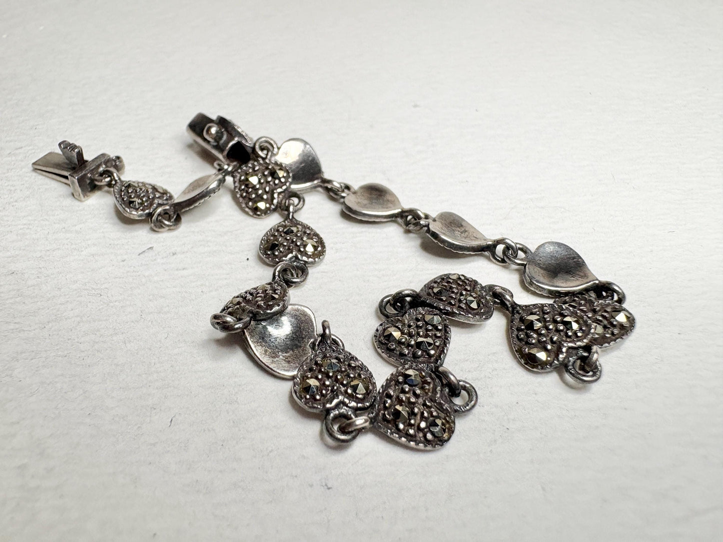 Sterling silver bracelet with oxidized marcasite heart links and a secure clasp.