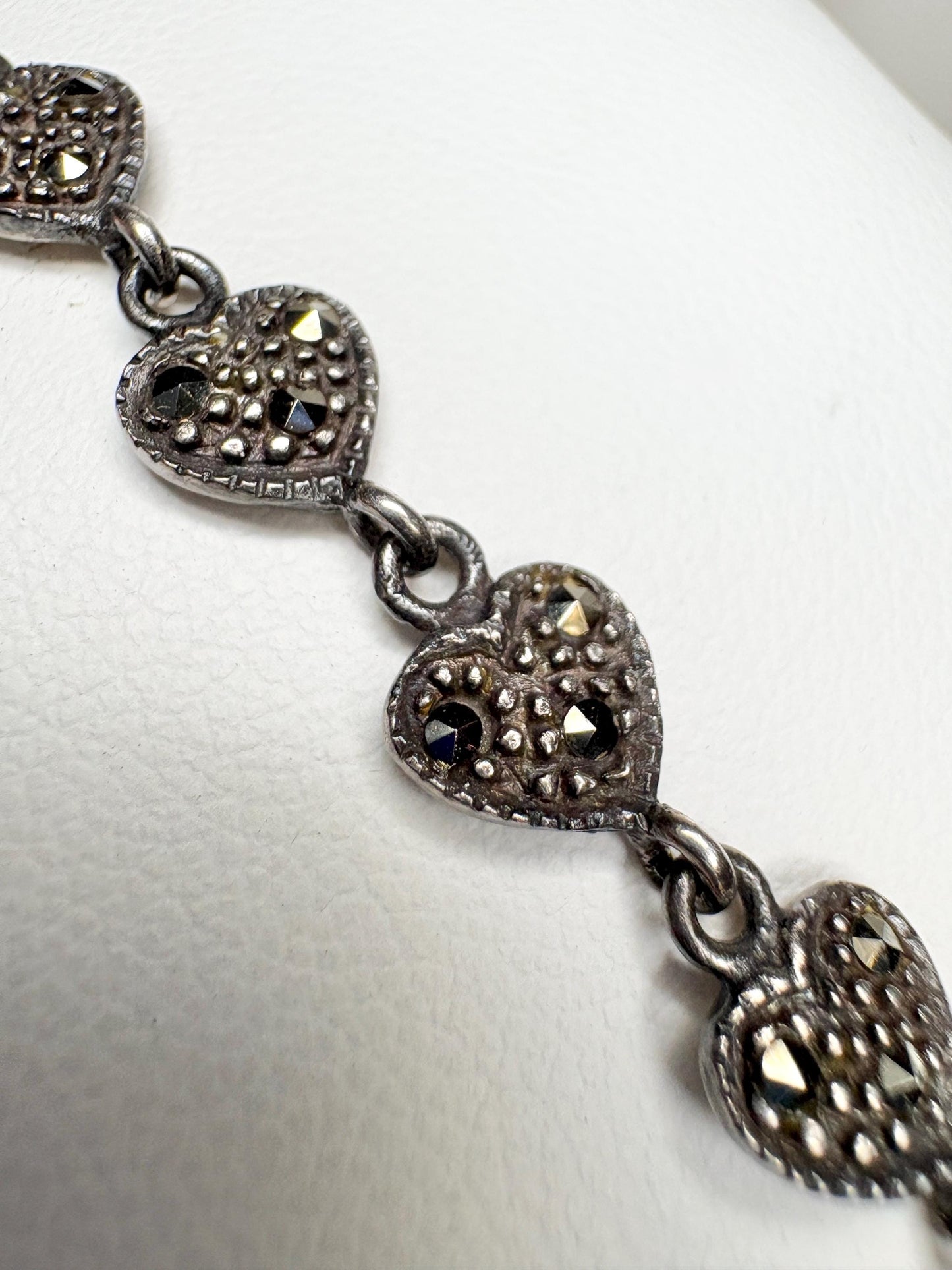 Sterling silver bracelet with oxidized heart links and marcasite stones.