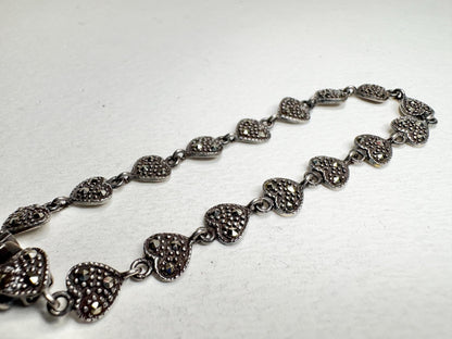 Sterling silver bracelet with oxidized marcasite-studded heart links.