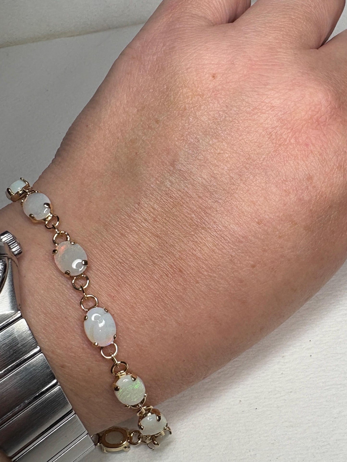 Gold plated tennis bracelet with oval Australian opals.